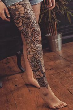 a woman's legs with tattoos on them