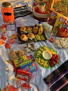 a table topped with lots of food and snacks