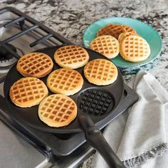 some waffles are cooking in a pan on top of the gas burner