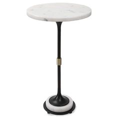 a white marble topped table with black metal base and gold trimmings on the top