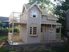 a small house with a deck on the front and second story in the back yard