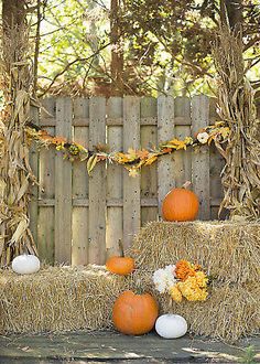 hay bales with pumpkins and flowers on them