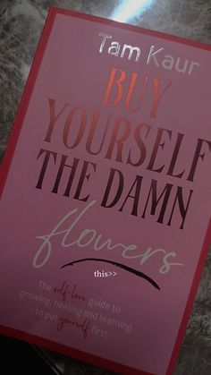 a pink book with the title buy yourself the damn flowers on it's cover