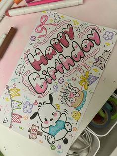 an image of a happy birthday card surrounded by markers and crayons