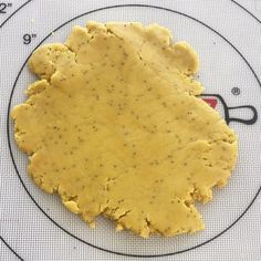 a piece of food that is on top of a plate with a measuring tape in front of it