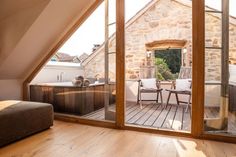 an open door leading to a patio and hot tub