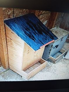 a television screen with a wooden box on it's side next to a trash can