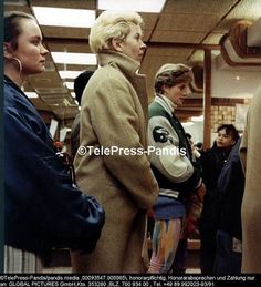 several people are standing in line at an airport