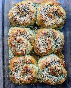 a tray filled with rolls covered in sesame seeds