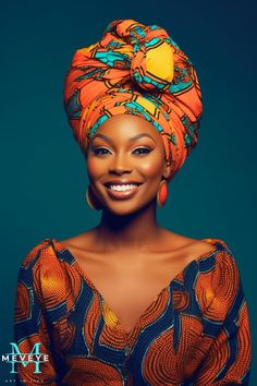 an african woman with orange and blue hair wearing a turban on her head