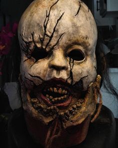 a person wearing a creepy mask with blood all over it's face and mouth