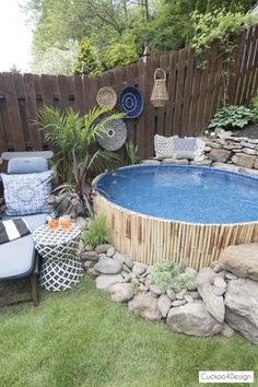 an above ground pool surrounded by rocks and plants