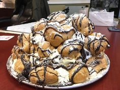 a pile of doughnuts sitting on top of a table covered in icing