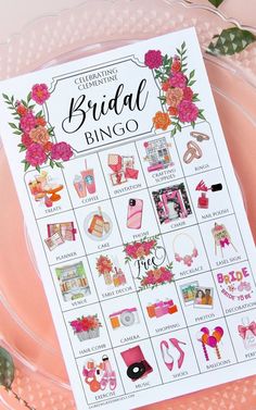 the bridal bingo game is sitting on a pink plate