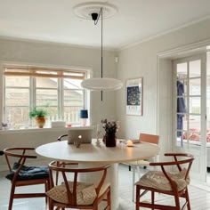 a dining room table with four chairs around it