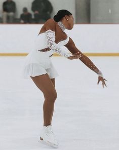 a female figure skating on an ice rink