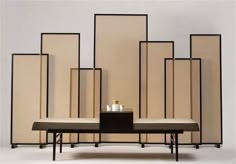 a bench with candles on it in front of wall dividers