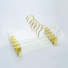 a set of seven clear and gold clothes hangers