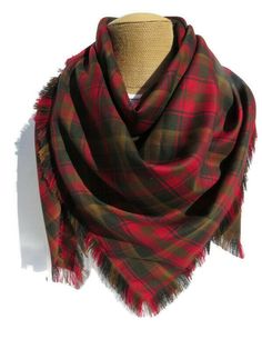 The brown and red plaid, Canadian Maple Leaf tartan blanket scarf makes a great accent to the wonderful winter coat you have or wear it to top off that sweater you feel so comfortable in.  It makes a great oversized scarf gift for that special lady on your list. Be practical and wear this to keep out the brisk breeze or use it to dress up your outfit.  This scarf is made of the same Maple Leaf tartan pattern that the Duchess of Cambridge wore in Canada. More recently Princess Kate wore it on the Tartan Blanket Scarf, Leaf Blanket, Canadian Maple Leaf, Leaf Scarf, Tartan Blanket, Tartan Scarf, Plaid Blanket Scarf, Canadian Maple, Tartan Fabric