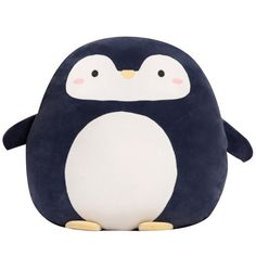 a small stuffed penguin sitting on top of a white floor