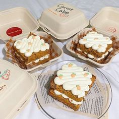 four pieces of cake sitting on top of a plate next to containers with frosting