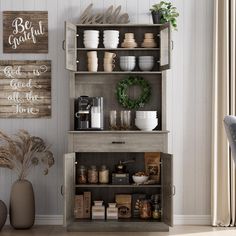 a shelf with dishes and cups on it next to a chair in a living room