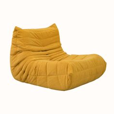 a yellow bean bag chair sitting on top of a white floor