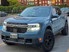 a blue pickup truck parked in a parking lot