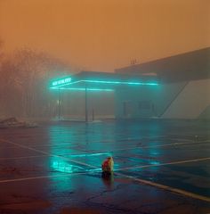 two people standing in the middle of an empty parking lot on a foggy day