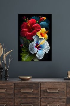 a painting of flowers on a wall above a dresser