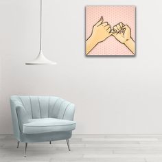 a blue chair sitting in front of a white wall with two hands holding each other