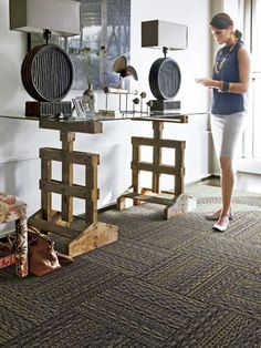 a woman standing next to a table with lamps on it