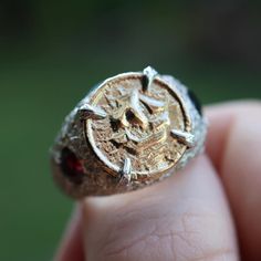 Process video on my instagram @nadinesuzannejewellery This unique and chunky statement ring was made to resemble treasure or a ring that a pirate would wear The solid 18ct yellow gold coin that has been set in this ring was made using an antique button as a mould and sand cast giving it a organic texture and look. Size: 8.5 - can be resized up to an 10 Gemstone: 1 x Sapphire and 1 x Garnet Metal : Ring - Sterling silver, Coin - 18ct yellow gold If you would like some similar created using your o Pirate Ring, Pirate Treasure, Sand Casting, Jewelry Workshop, Casting Jewelry, Jack Sparrow, Chunky Rings, Antique Buttons, Gold Coins