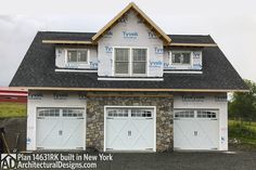 a two story house with three garages on the front and one above the garage