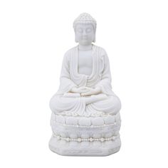 a white buddha statue sitting on top of a table