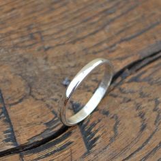 a silver ring sitting on top of a wooden table