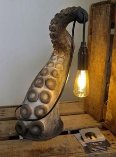 a light that is sitting on top of a wooden box next to an old fashioned lamp