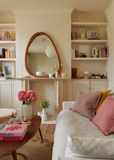 a living room filled with furniture and a mirror