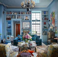 a living room filled with furniture and a chandelier