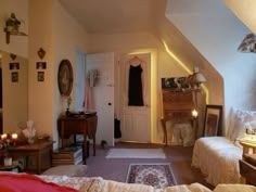 an attic bedroom with two beds and a dresser