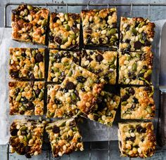 several squares of food sitting on top of a cooling rack next to a knife and fork