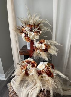 a basket with flowers and feathers on it