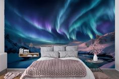 a bed room with a neatly made bed and an aurora bore mural