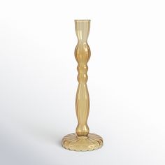 a gold colored vase sitting on top of a white table