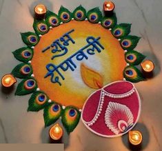 a decorated diya with peacock feathers and candles