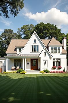 White cottage with lush green lawn and trees in the background. The undeniable charm of cottage homes brings a rustic fairytale to life with each brick and beam.