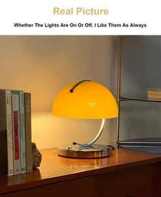 a yellow lamp sitting on top of a wooden table next to a bookshelf