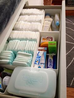 an organized drawer with toothbrushes, soaps and other hygiene products in it