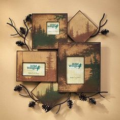 four wooden frames with pine cones hanging on the wall