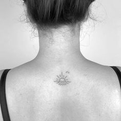 a woman with a small sun tattoo on her back